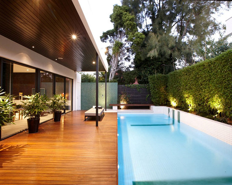 Luxury Deck Ideas - outdoor wooden deck running along a rectangular small pool  in a villa - LifetimeLuxury042