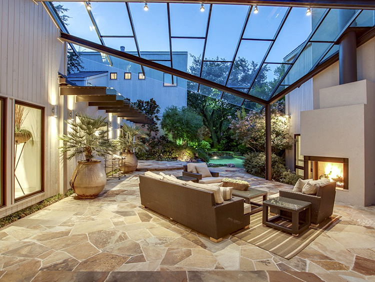 Luxury Patio Ideas - avant-garde patio immersed in the garden with floor made out of an iron frame and glass panels - LifetimeLuxury004